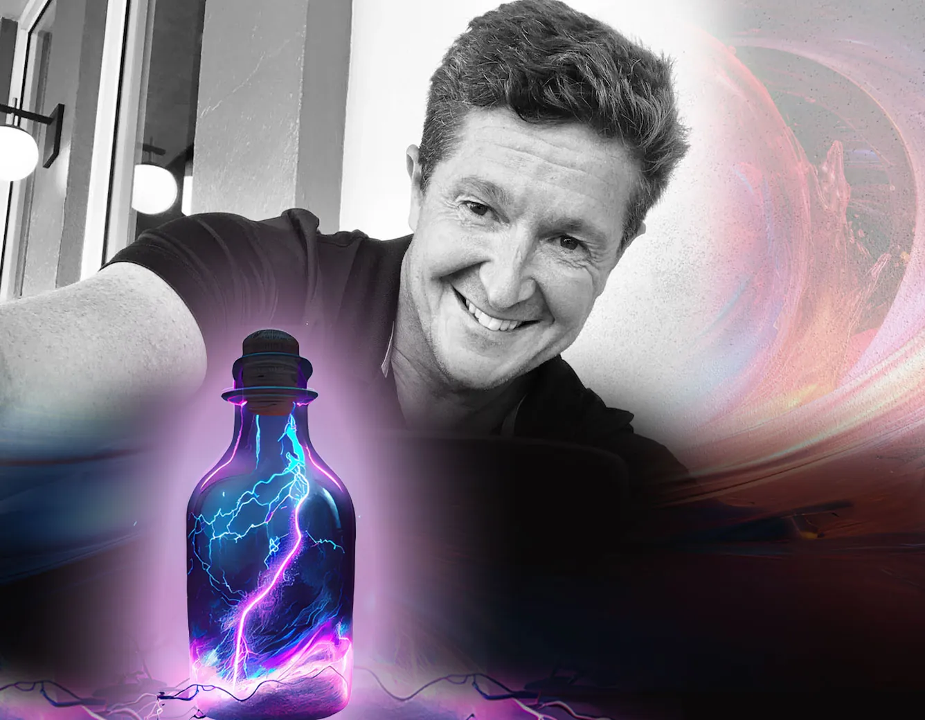 Jason Stevens smiling behind a glass bottle holding a bolt of purple lightning